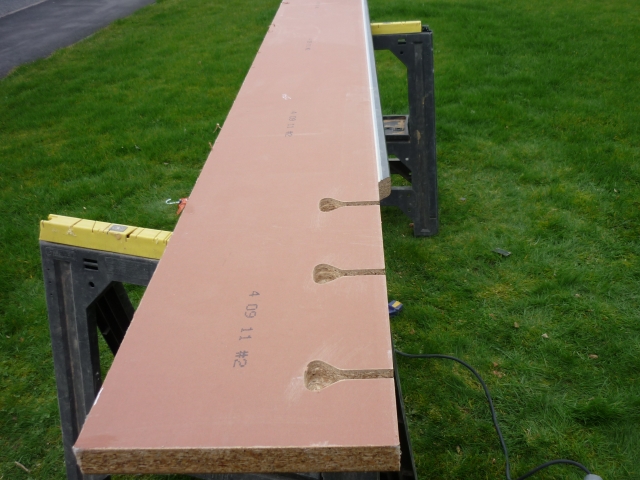 A worktop on trestles with three dog bone bolt cut-outs along the joint