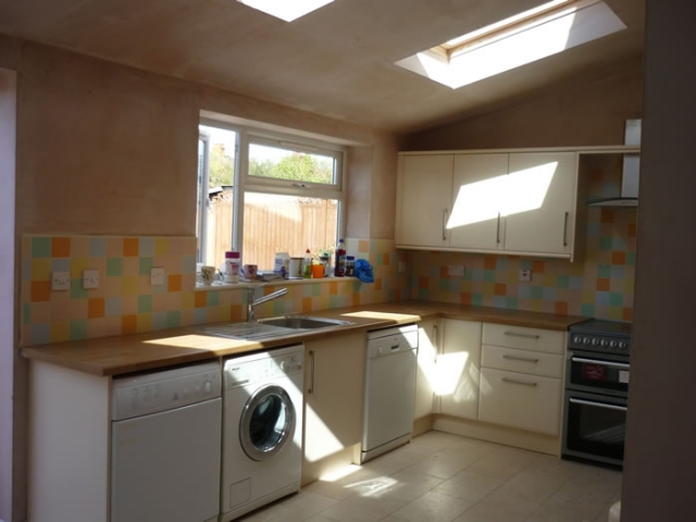 Long run of cream units under a window with a skylight above