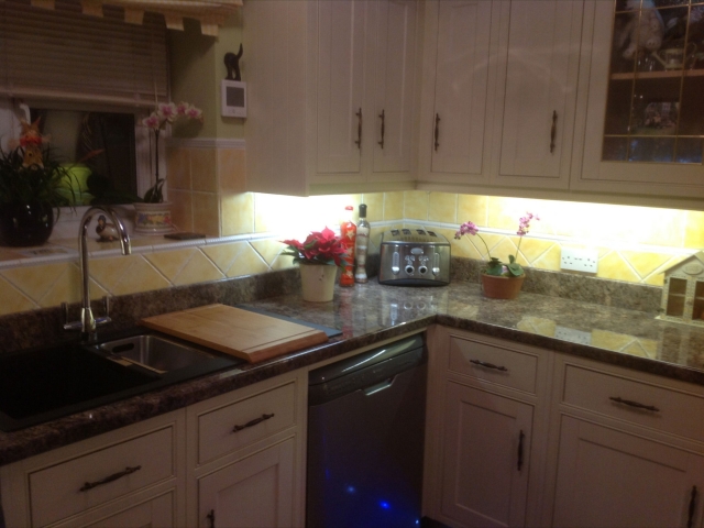 Cream shaker kitchen with stone-effect worktop and under-cabinet lighting