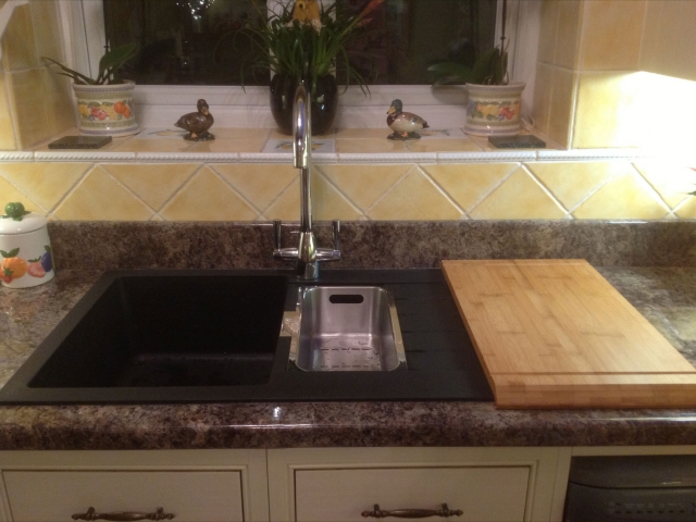 Black inset sink with chopping board and mixer tap